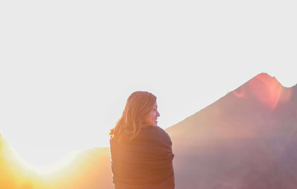 woman standing near mountain during daytime