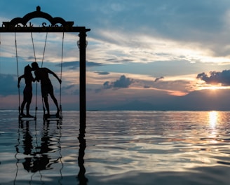 a couple standing in the sea while kissing
