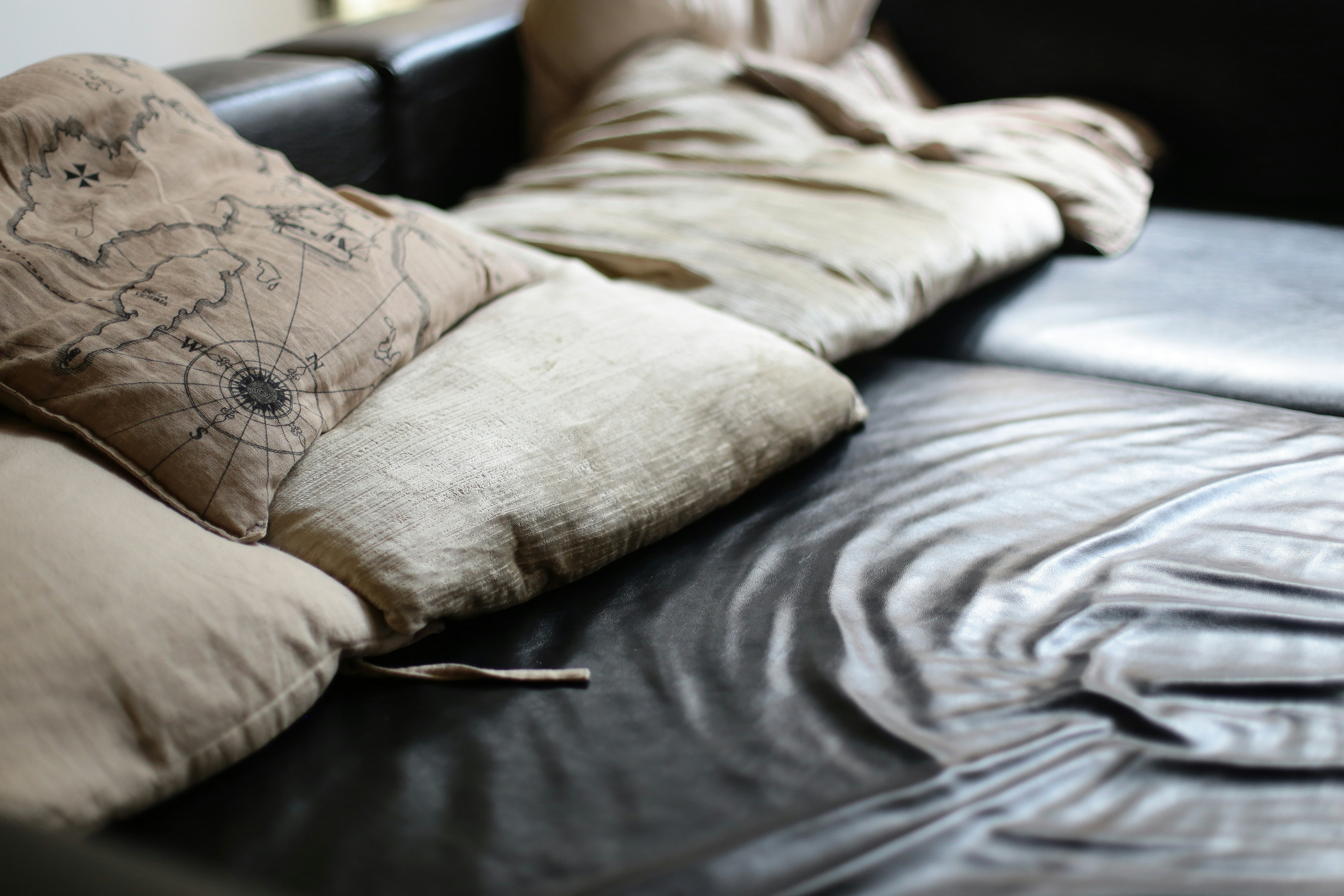 Leather couch cream pillows