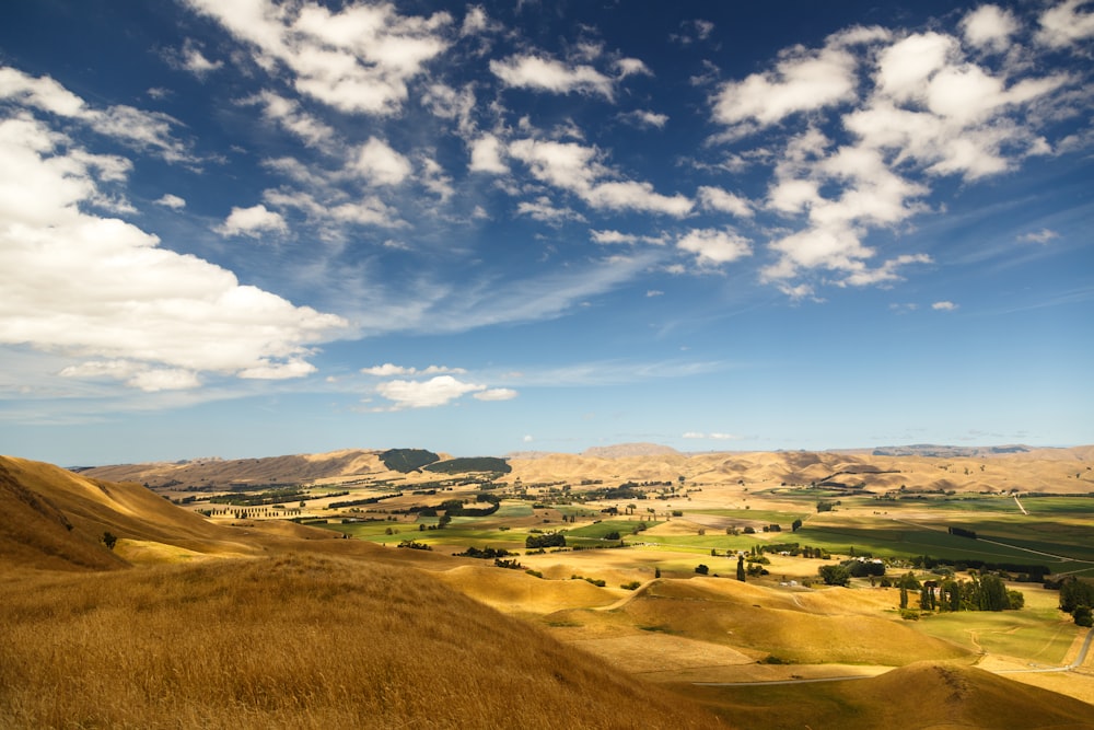 brown hills under cloudy sky