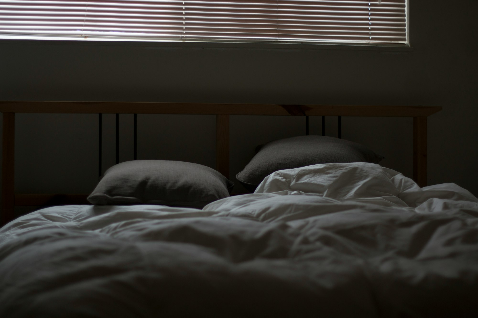 Messy bed and closed blinds