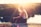 woman sitting on brown surface watching at body of water