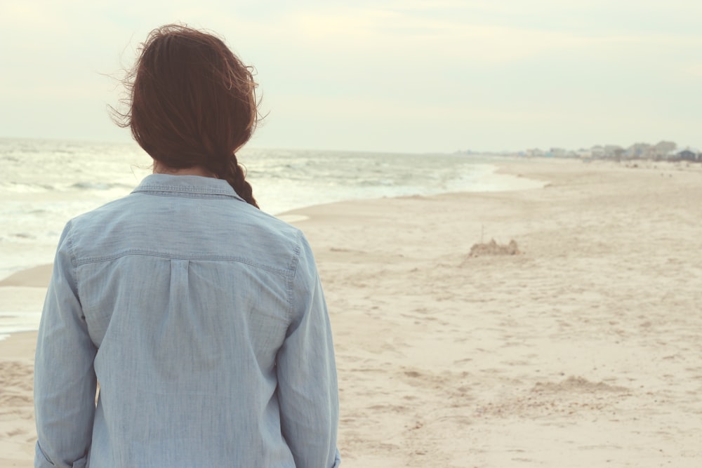 back view of woman standing near sea