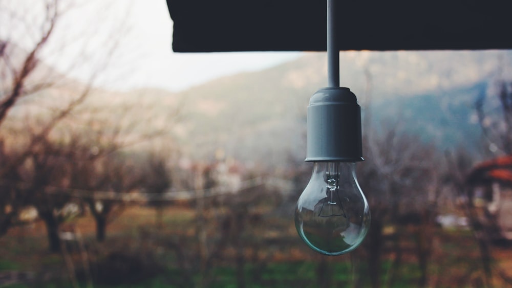 a light bulb hanging from a black umbrella