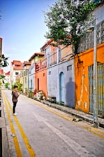 A vibrant street scene in Lefkada with tourists using smartphones to navigate local spots.