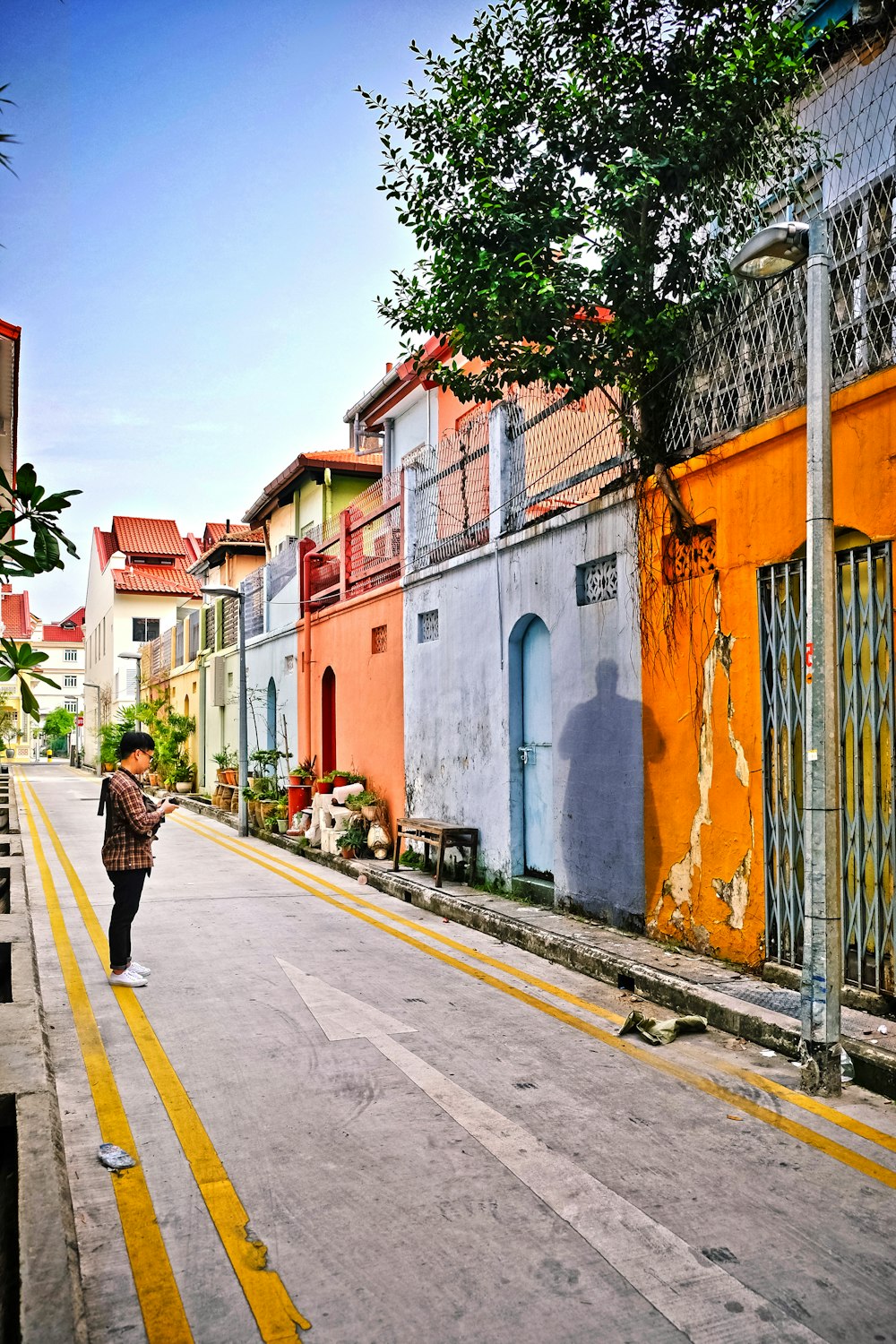 man standing on street facing wall