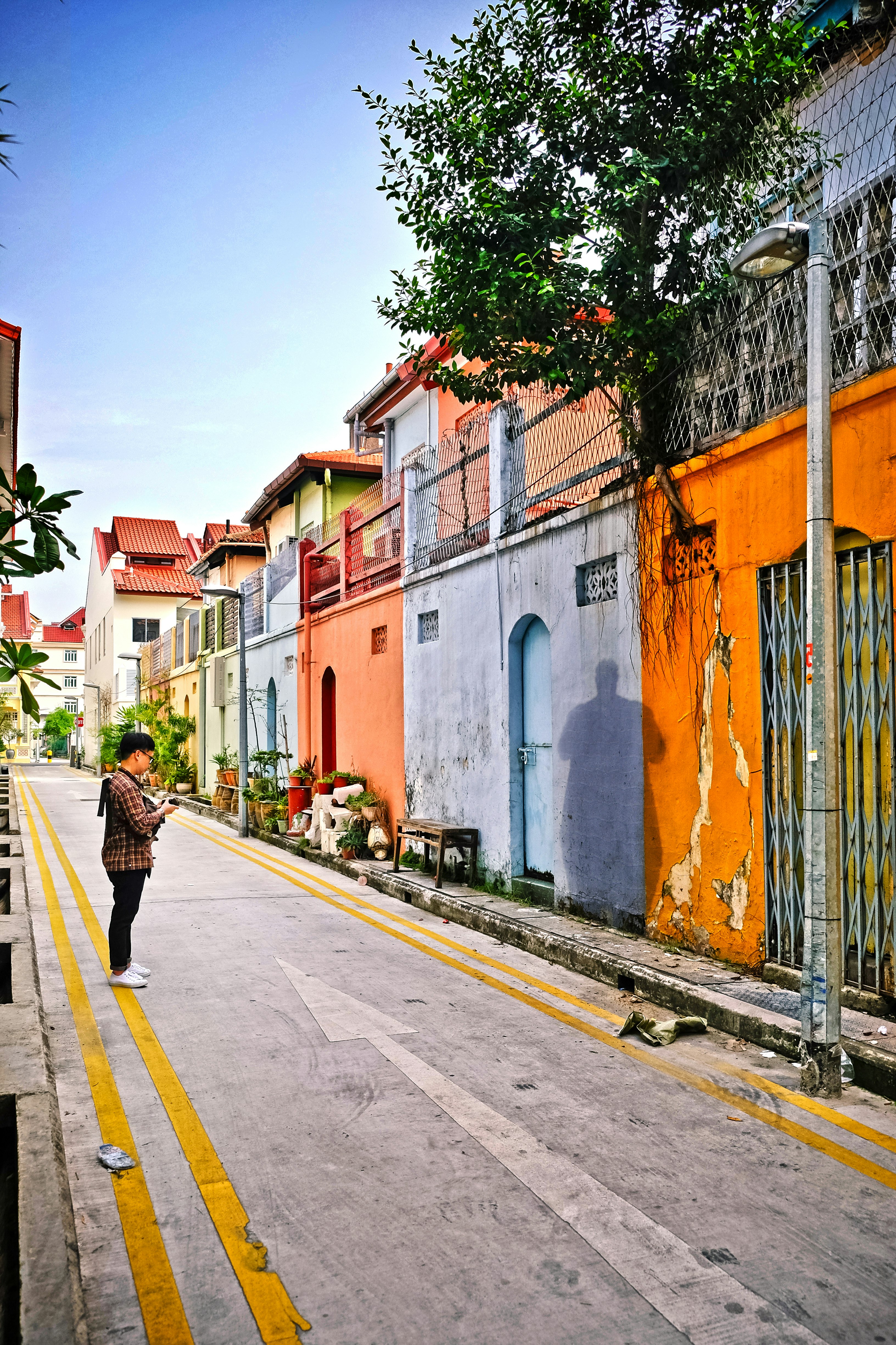 man standing on street facing wall