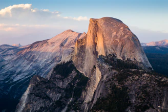 A panoramic view of the iconic Torres del Paine granite towers glowing in the golden hour light.