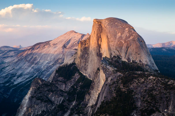 A panoramic view of the iconic Torres del Paine granite towers glowing in the golden hour light.