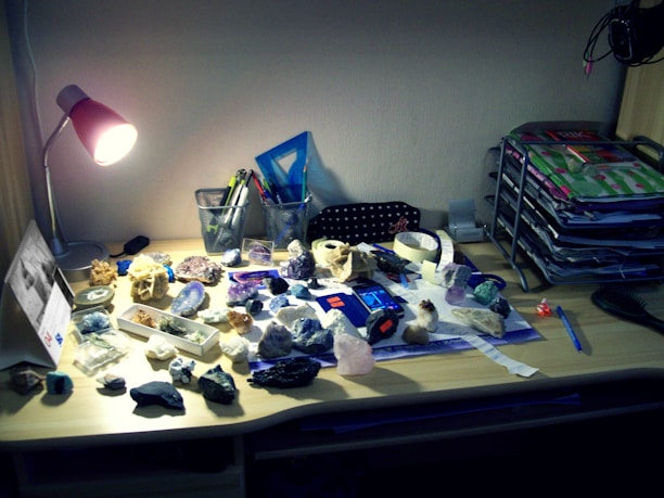 Close-up of geological maps and mining equipment on a desk.