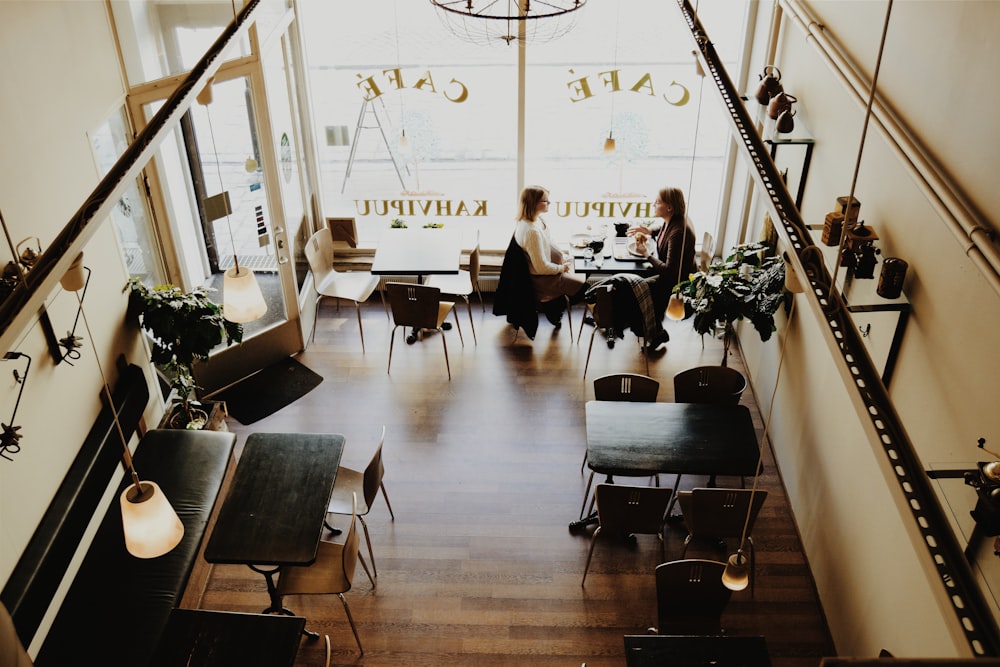 two women sitting in the cafe chatting