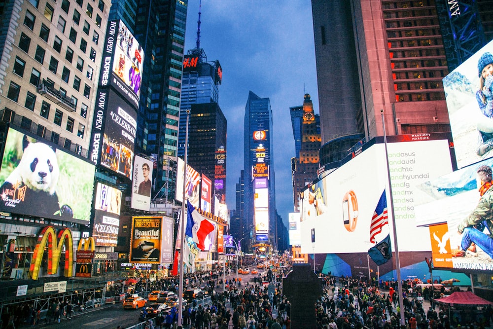 people standing near billboards