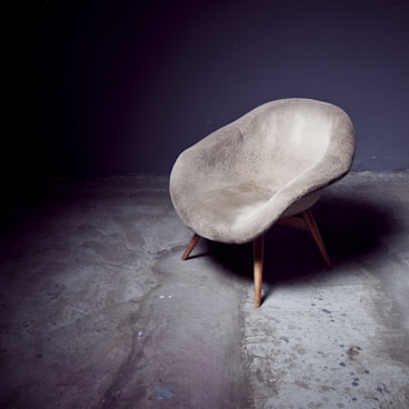 brown bucket chair near wall