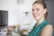 A smiling customer service representative assisting a client at a desk.