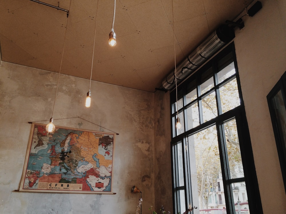 gray pendant lamps inside concrete building at daytime