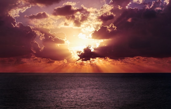 photo of a body of water and sunrise
