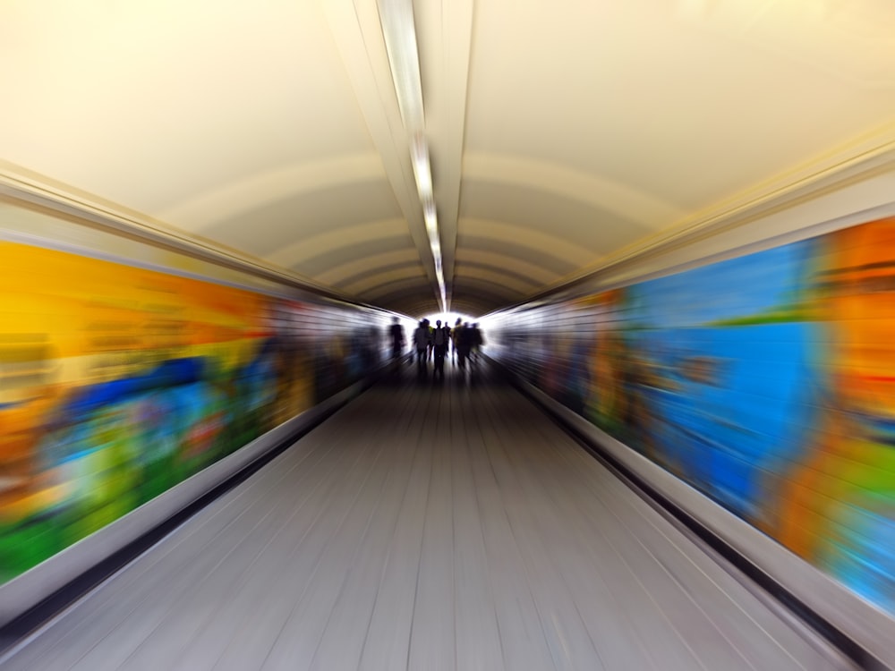 a blurry photo of people walking in a subway