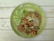Close-up of a beautifully plated Pad Thai with fresh herbs and lime wedges.