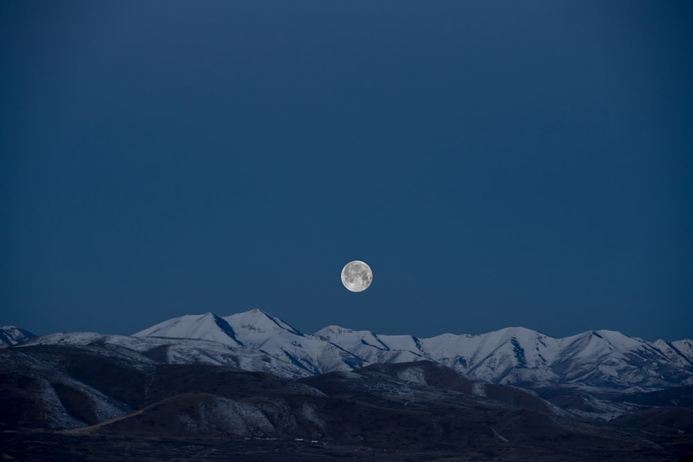 full-moon above snow-capped mountain painting