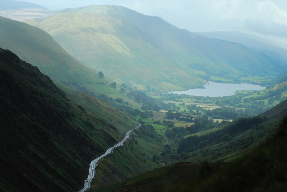 river at middle of mountains near forests