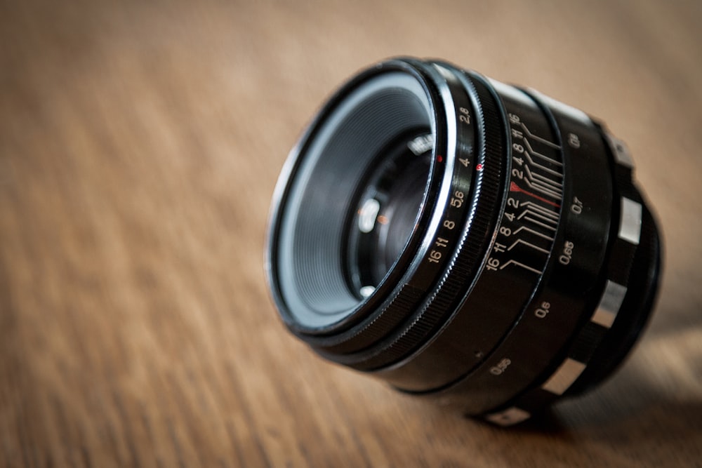 a camera lens sitting on top of a wooden table