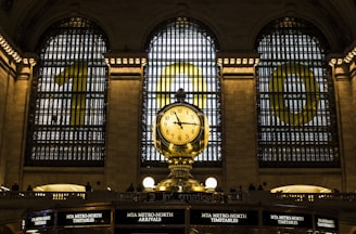 gold clock with time of 11:15