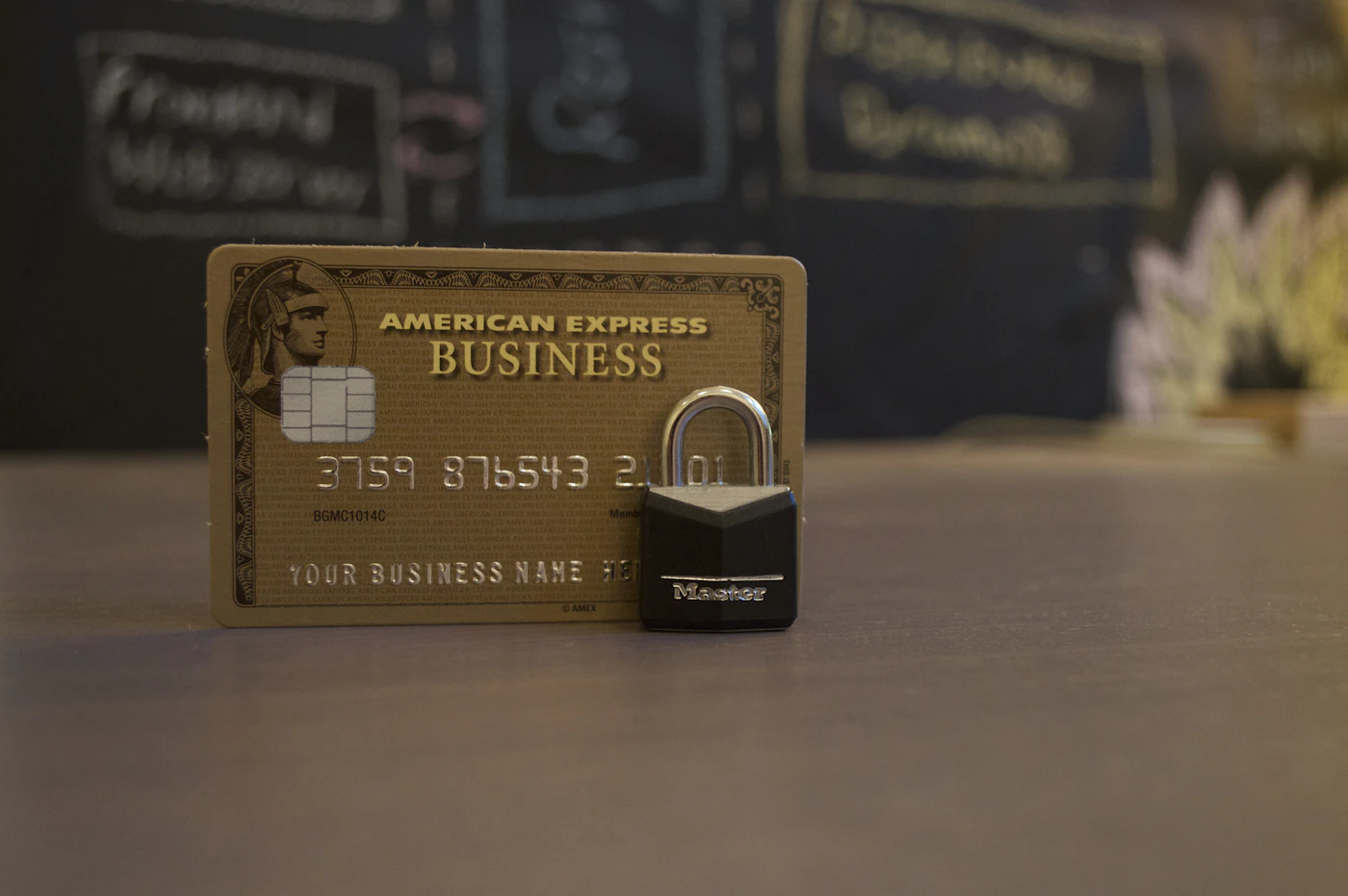 An American Express Business card next to a black padlock