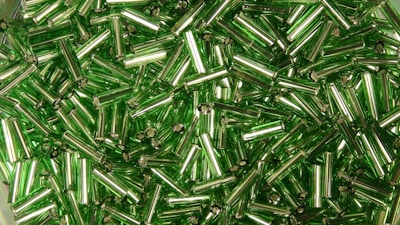 Close-up of shiny recycled metal pieces reflecting sunlight.