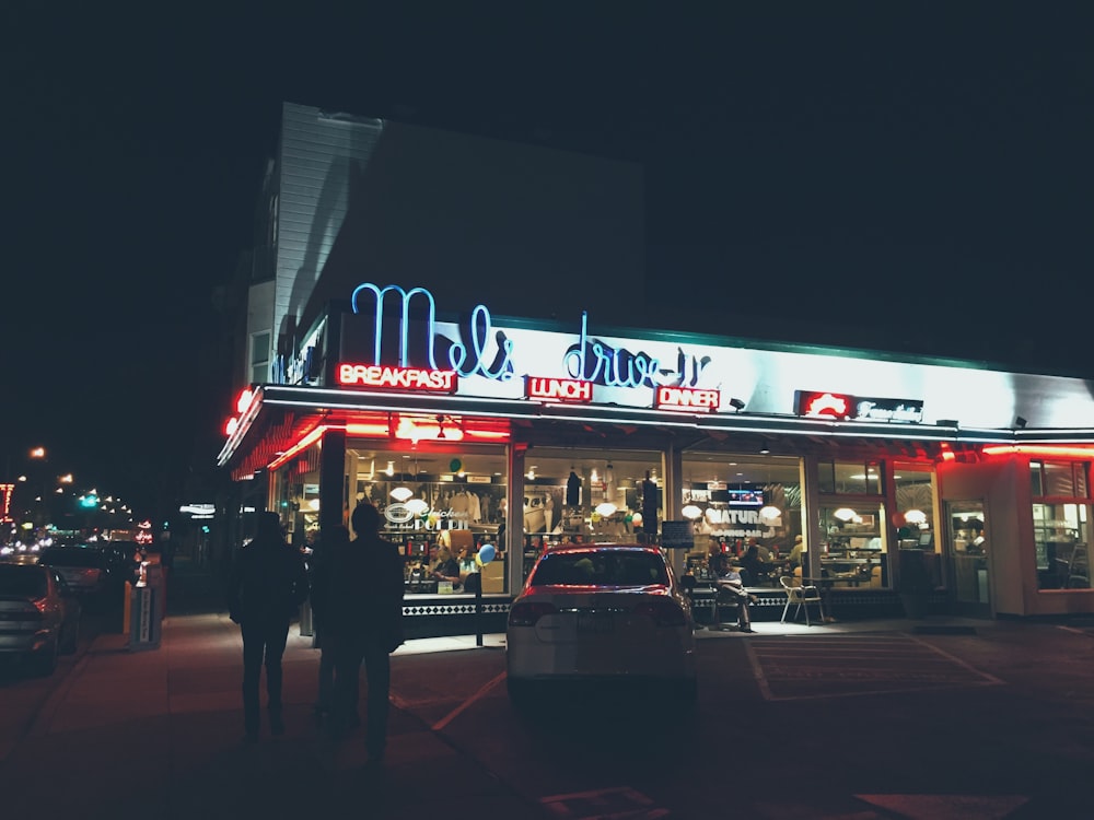 white vehicle parked in front of store