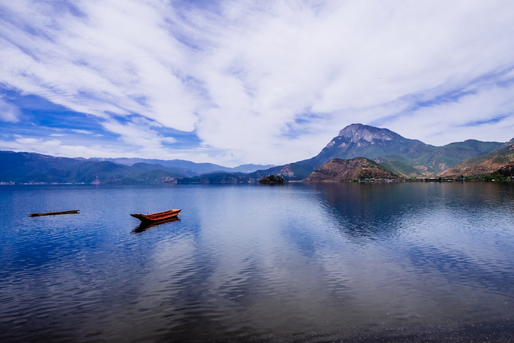 red boat on body of water