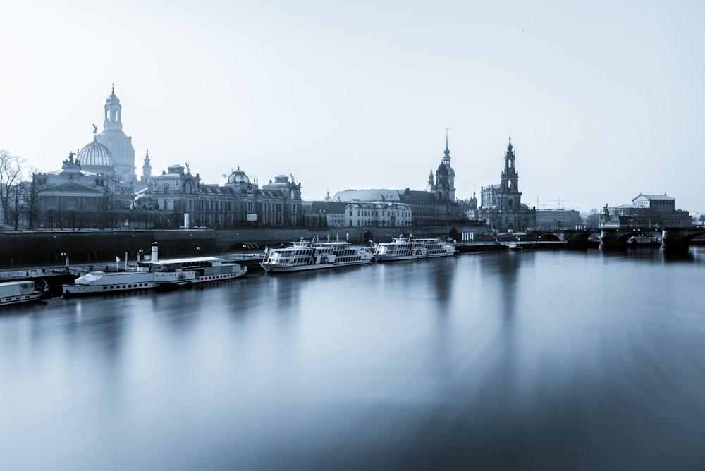 city buildings near body of water with yachts