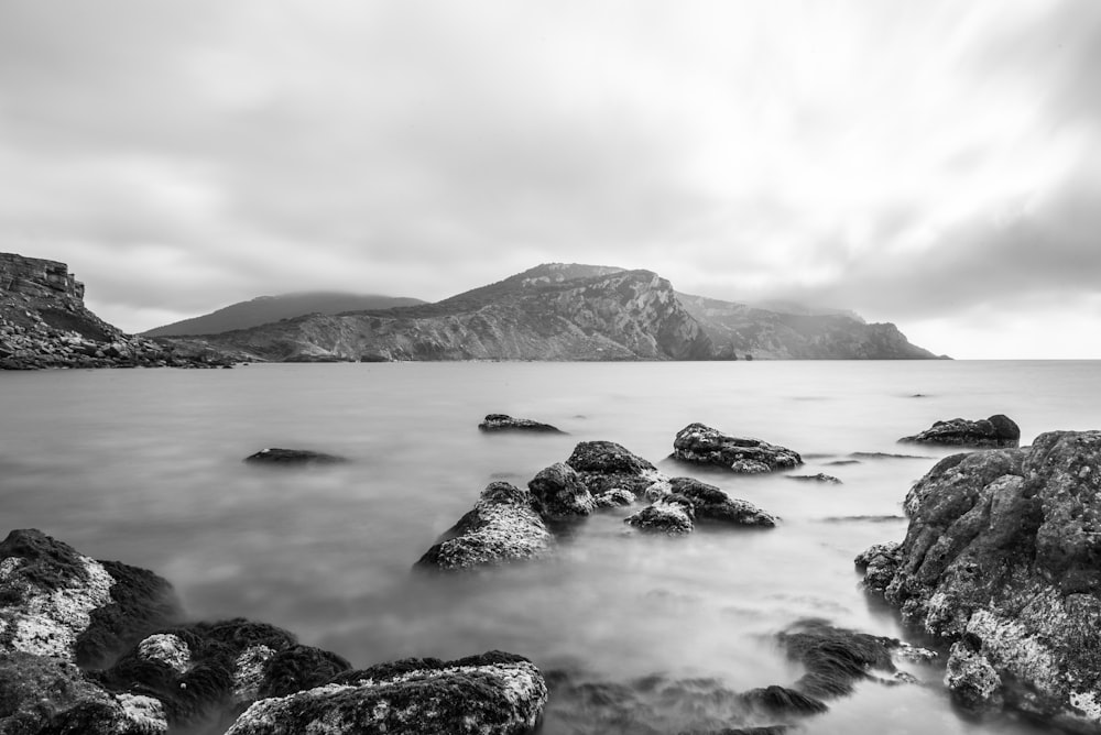 gray and black mountain near of body water