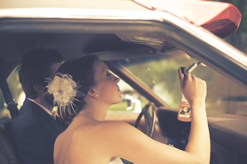 man and woman sitting inside the vehicle