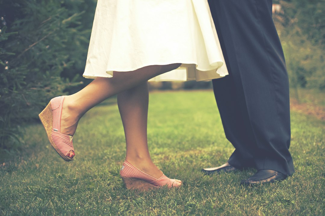 woman and man standing on grass, Couple stands together on grass