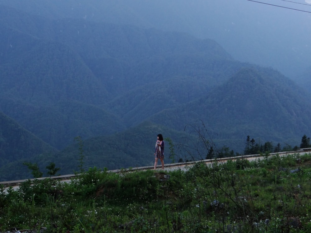 woman standing near mountain during daytime