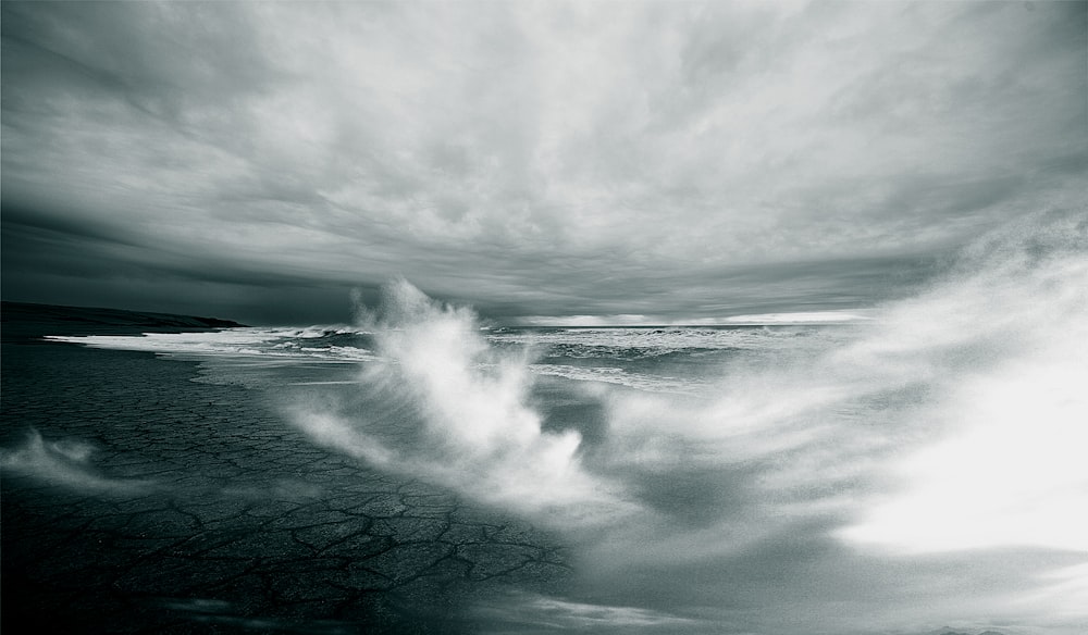 body of water on dried land under white clouds wallpaper