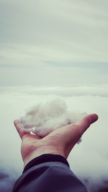 shallow focus photography of man holding snow during day time