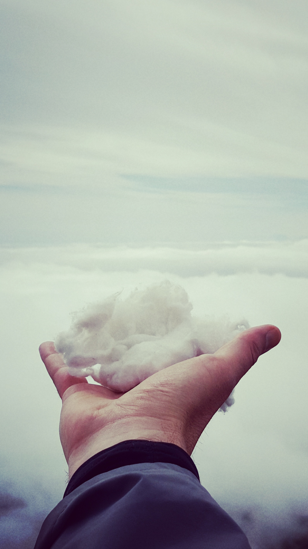 shallow focus photography of man holding snow during day time