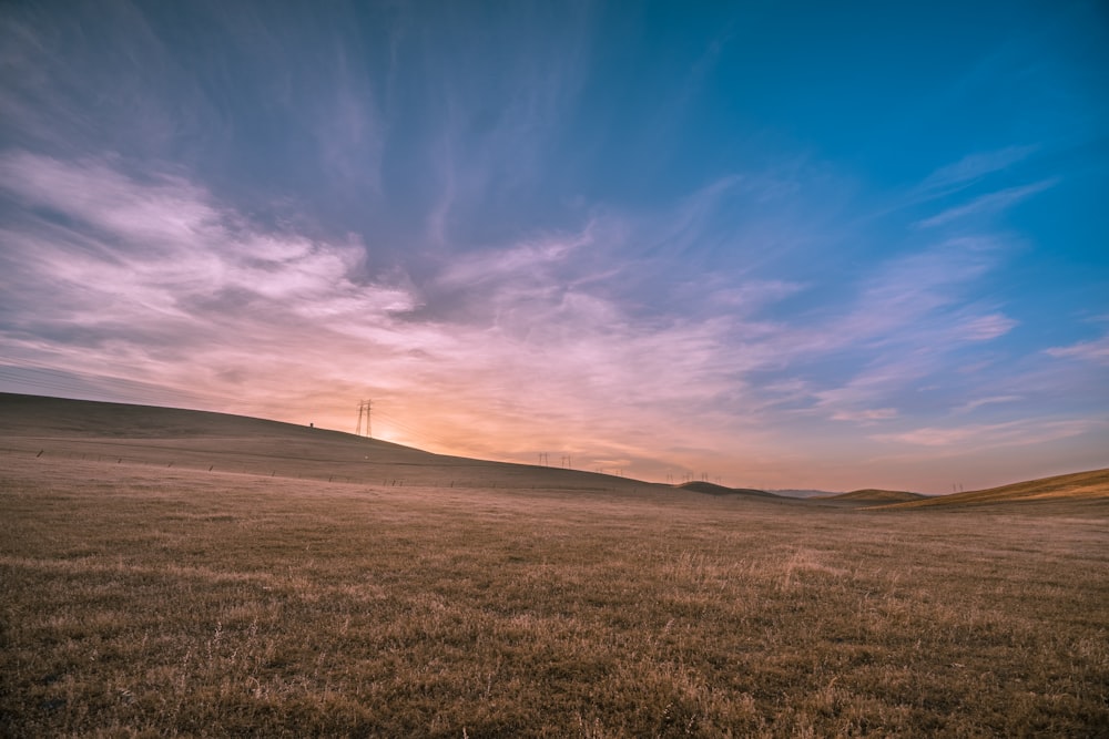 青空下の褐色野原の風景写真