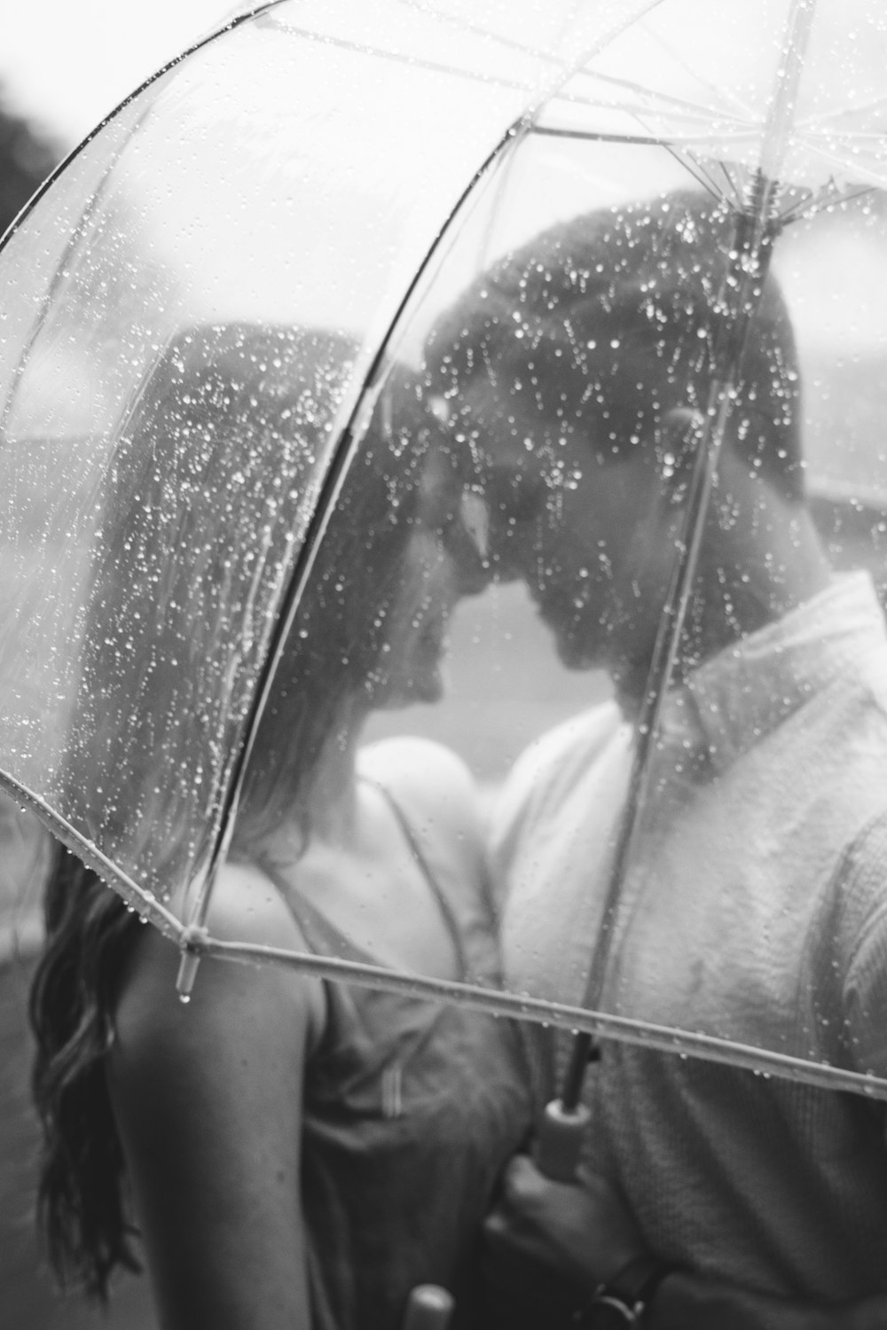 couple under clear umbrella