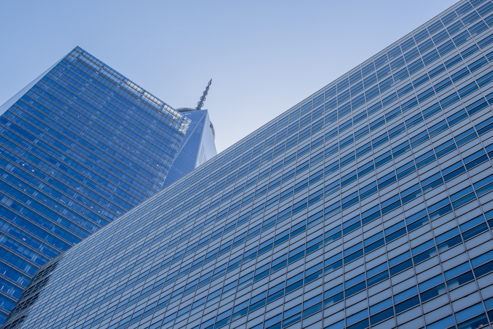 Fotografie aus der Wurmperspektive eines blauen Betongebäudes unter strahlend blauem Himmel