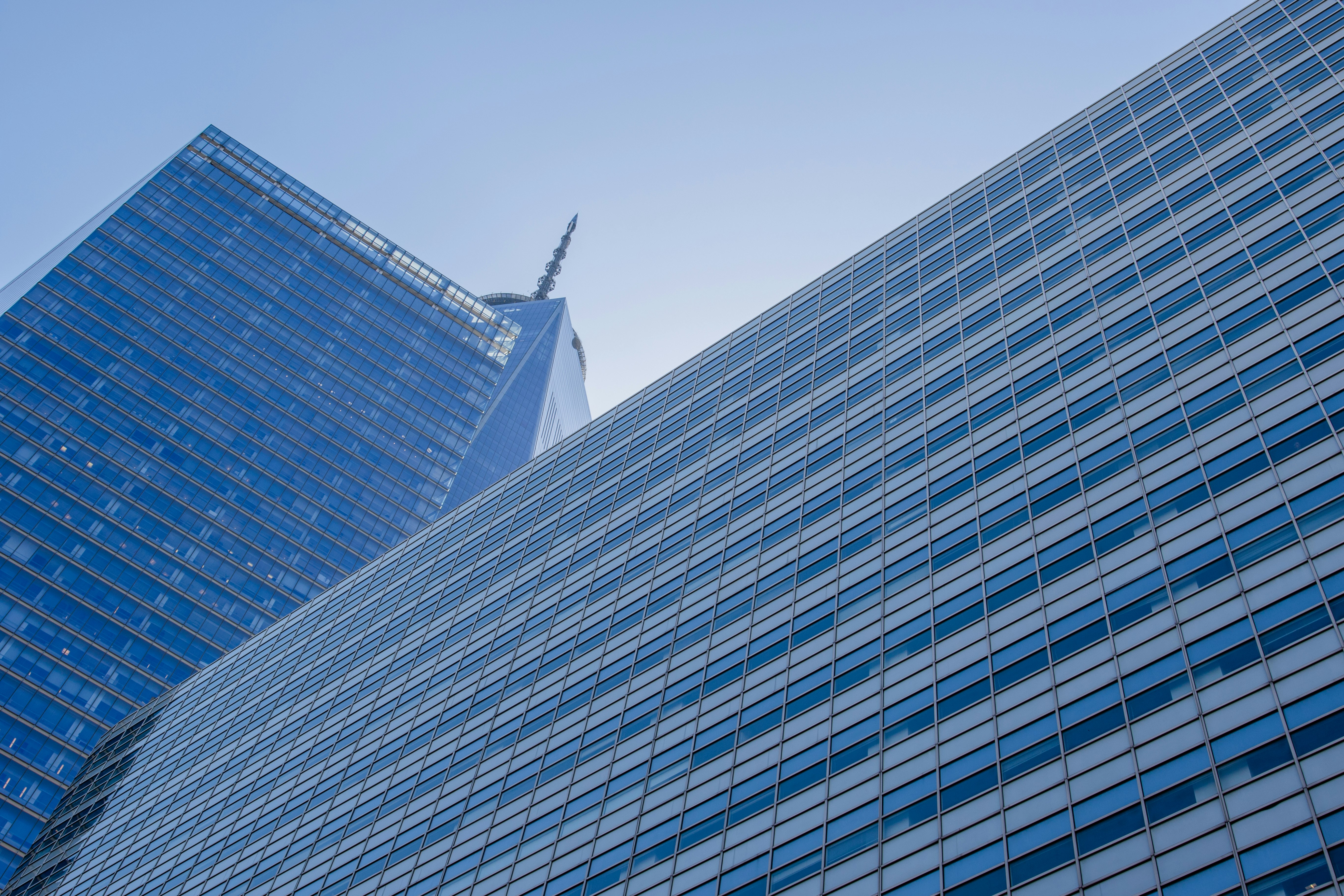 worm's-eye view photography of blue concrete building under clear blue sky