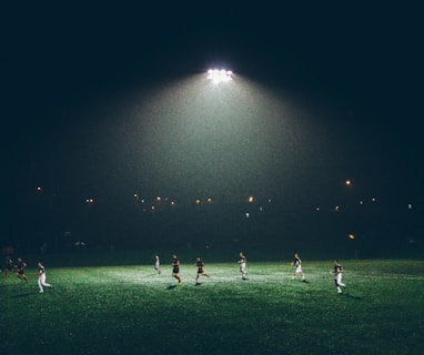 group of people playing soccer on soccer field