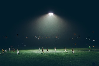 group of people playing soccer on soccer field