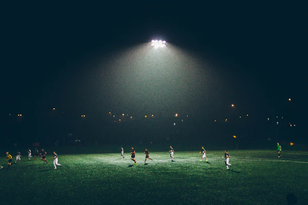 Students playing football on outdoor field
