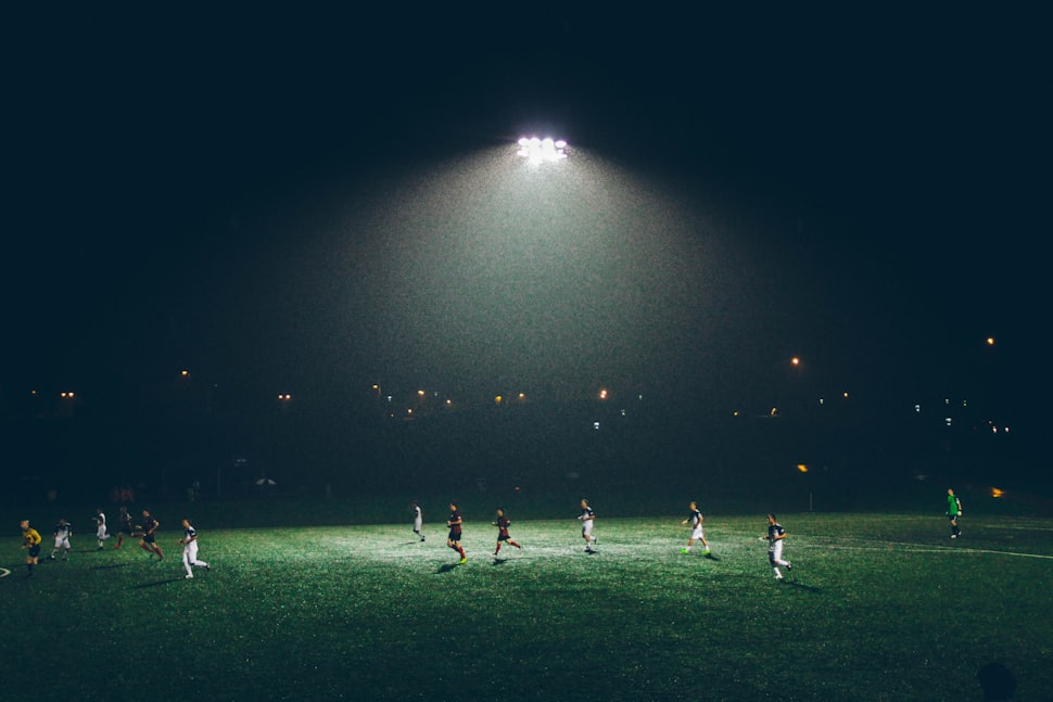 Football match at night under floodlights
