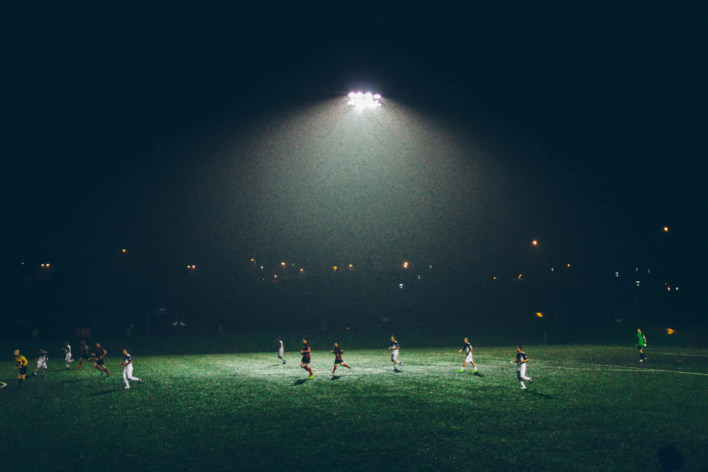 Football players competing under stadium lights, representing Spain’s World Cup semifinal victory over France.