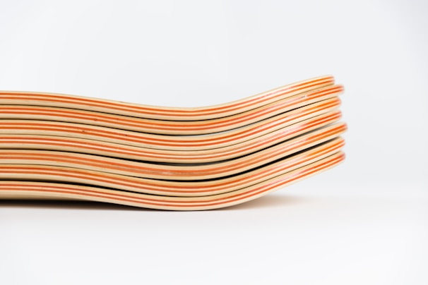 A stack of freshly pressed and aged decks drying in the workshop.