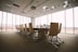 oval brown wooden conference table and chairs inside conference room