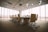 oval brown wooden conference table and chairs inside conference room